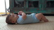 © Marco - Baby lying on soft mat, relaxed posture, quiet observation, gentle movement, exploring surroundings, early development, peaceful moment, comfortable and safe environment