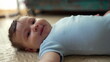 © Marco - Baby lying on floor, looking at camera with gentle gaze, peaceful and relaxed, early development stage, calm moment, quiet observation, safe and nurturing environment