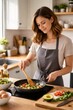 © Татьяна Евдокимова - Young woman in apron preparing a healthy meal, stirring fresh vegetables in a cooking pan on an induction hob, surrounded by various ingredients in a modern kitchen