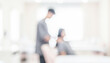 © al-sultan - A blurred image depicting a hair stylist working on a client's hair in a modern salon. Soft lighting enhances the professional atmosphere of the setting.
