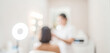 © al-sultan - A blurred image of a beauty salon scene featuring a client receiving a treatment. Soft lighting enhances the serene, professional atmosphere.