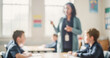 © al-sultan - A classroom scene with a teacher engaging with students. The teacher is standing in the background while students attentively listen during a lesson.