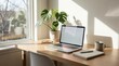 © Noor - Workspace serenity: A well-lit and organized workspace. A laptop takes center stage on a sleek wooden desk, complemented by a potted plant and a notebook.