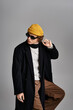 © LIGHTFIELD STUDIOS - Stylish handsome man showcasing vibrant fashion against a minimalist backdrop in a creative pose