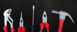 © Jess rodriguez - Set of basic hand tools including pliers screwdriver and hammer arranged on a dark background