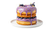 © Hans - Luxurious stacked donuts with vibrant purple glaze, golden patterns, fresh blueberries, and lavender sprig, isolated on a plate for gourmet dessert concepts