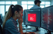 © Raisa - Woman programmer looks at computer screen with error alert. She covers mouth in shock reacting to critical software failure or cyber threat. Panic on face as code displays red warning message.