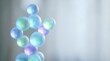 © Yuliia - Floating translucent soap bubbles with iridescent rainbow colors against soft blurred background for relaxation and wellness concepts.