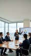 © Yuliia - Professional blonde businesswoman presenting strategy to corporate team in modern conference room with city skyline view during executive meeting.