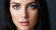 © editin - A stunning close-up portrait of a beautiful young woman with striking blue eyes and dark hair, exuding elegance and allure