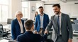 © twilight mist - Business professionals greet a new colleague with a handshake in a bright office setting