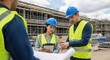 © twilight mist - Construction supervisors review building plans and digital notes at an active development site.