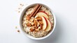 © Nasr - Hearty oatmeal breakfast with sliced apples, almonds, and cinnamon sticks, top-down view