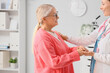 © Pixel-Shot - Mature woman with gynecologist holding hands in clinic. Menopause concept