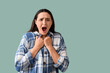 © Pixel-Shot - Young woman screaming on green background