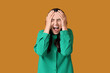 © Pixel-Shot - Young woman screaming on orange background