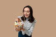© Pixel-Shot - Happy young woman holding Easter basket with decorative cosmetics on color background