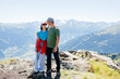 © Elena Medoks - Father and daughter embracing on mountain peak, enjoying scenic view
