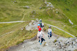 © Elena Medoks - Family hiking on mountain trail, enjoying scenic views