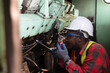 © arrowsmith2 - African Technical Engineer Repairing Industrial Engine in Mechanical Workshop