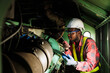 © arrowsmith2 - African Engineer Inspecting Industrial Machinery with Digital Tablet