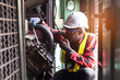 © arrowsmith2 - Skilled African Mechanic Repairing Large Engine in Industrial Workshop