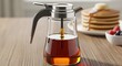 © CG - Glass syrup dispenser with stainless lever flip top filled maple syrup breakfast accessory