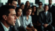 © P.W-PHOTO-FILMS - A man speaks intently before a group of diverse professionals in a modern office setting.