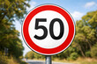 © Ram - Speed limit 50 road sign on roadside, traffic regulation symbol outdoors, maximum driving restriction marker, transport safety control concept, highway law enforcement warning, circular street sign cl