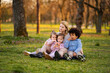 © Jelena - Mother and children enjoying a park outing and snacking