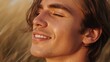 © Future Vision - Smiling man with closed eyes showing stubble and freckles among tall dry grasses, golden-hour light