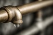 © whitestorm - A close-up shot of a brass pipe fitting with a single, suspended water droplet highlighting conservation issues and the potential wastage of precious resources.