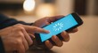 © AlIKY - Person holding smartphone and touching screen with loading spinner icon while waiting for application or website to load against warm blurred indoor background. Concept of slow internet connection and