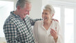 © peopleimages.com - Phone, elderly and couple in home with happiness, reading good news or notification. Mobile, senior man and woman in house for internet, connection or share message for pension increase in retirement