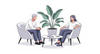 © DT - Two people in conversation in comfortable chairs.
