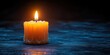 © littlekid - single lit orange candle with dripping wax and visible wick on a dark textured blue surface, warm glowing flame and soft reflection, calm and contemplative atmosphere