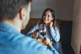 Smiling Woman Toasting With Partner Over Red Wine During Romantic Restaurant Date Night