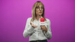 © Krakenimages.com - Middle aged woman with glasses and white shirt holds news microphone with palm up gesture in studio; informative confidence.
