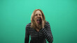 © Krakenimages.com - Woman cupping hands to shout with mouth wide open in studio green screen wearing striped top; announcement urgent.