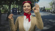 © Krakenimages.com - Woman in uniform holding german passport showing ok gesture at park suggests travel with confidence.