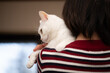 © hakase420 - 飼い主に抱かれている白い猫
