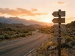 © Leo Rohmann - Enigmatic road signs against a breathtaking sunset landscape conveying adventure, relaxation, nourishment, and connectivity in harmonious natural surroundings