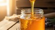 © Nurnobi - Natural Golden Honey Pouring into a Jar with Lavender on a Rustic Wooden Table