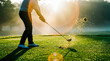 © Aurora Aesthetics - Golfer swinging club on green grass fairway with bright sun flare and flying dirt dynamic action shot sports lifestyle outdoor recreation leisure hobby