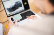 © Studio Marmellata - A person uses a credit card to make an online purchase of a vehicle displayed on a laptop screen.