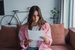 © Daniel - Worried young Caucasian woman indoor read post paper letter think of bad news or problem in notice, distressed millennial female frustrated confused by negative response in postal paperwork mail 