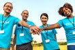 © Rawpixel.com - Diverse volunteers joining hands outdoors.