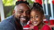 © syhin_stas - Juneteenth celebration bringing family together, a happy African American young man smiling at table, sharing joy and cultural pride in holiday gathering. Juneteenth