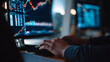 © A2Z AI  - Person analyzes stock market charts and financial data on a computer screen in a dimly lit office environment late at night
