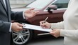 © ANDREY PROFOTO - Customer signing new car purchase agreement at dealership
